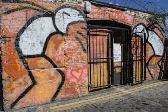 Graffiti art wall behind a group of artists sharing a moment in the studio.