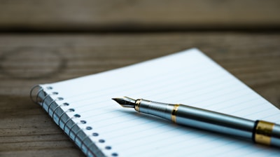 fountain pen on spiral book