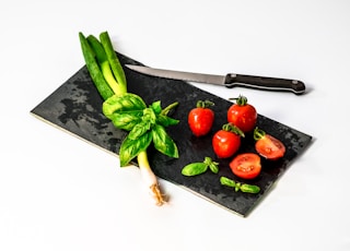 slice of tomato on board beside knife