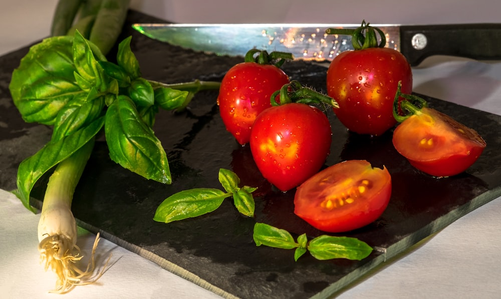 red tomatoes on black plate