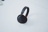 Stylish wireless headphones resting on a minimalist white table