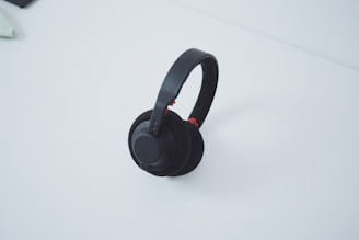 High-quality wireless headphones resting on a minimalist white table.