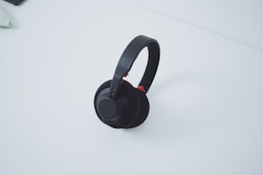 High-quality wireless headphones resting on a minimalist white table.