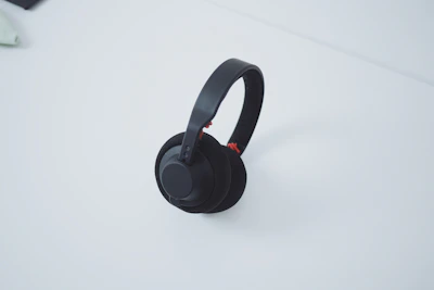 Stylish wireless headphones resting on a minimalist white table