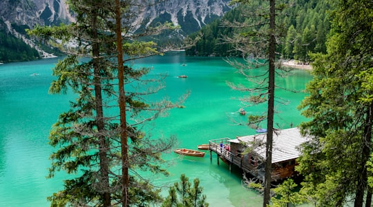 high angle photography of wooden boats on lake near cabin in Parco naturale di Fanes-Sennes-Braies Italy