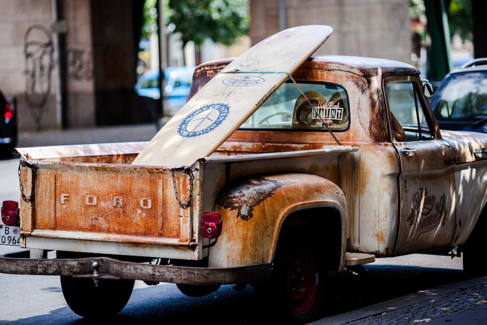 vintage brown and white Ford single-cab pickup truck parked on pavements