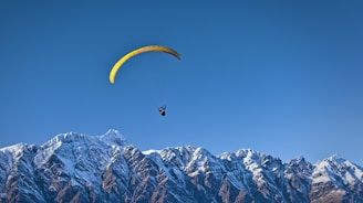 man on parachute near the mountain