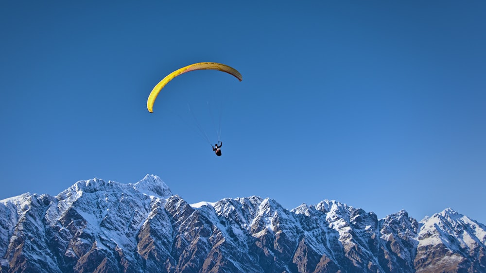 man on parachute near the mountain