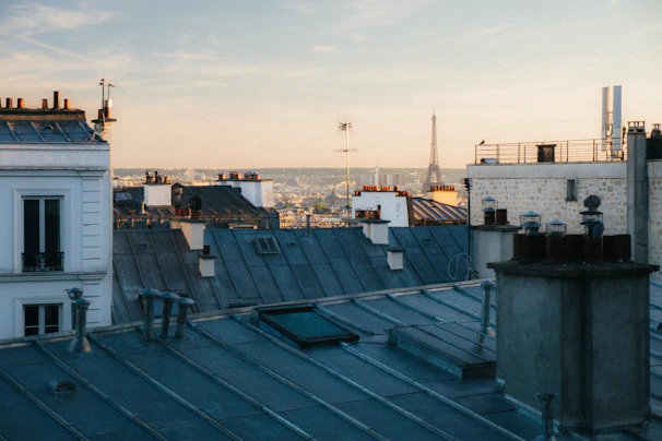 Balcony view overlooking classic Paris rooftops at sunset