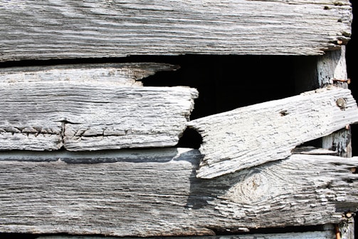 Close-up of weathered wooden planks being restored on the Oriav.