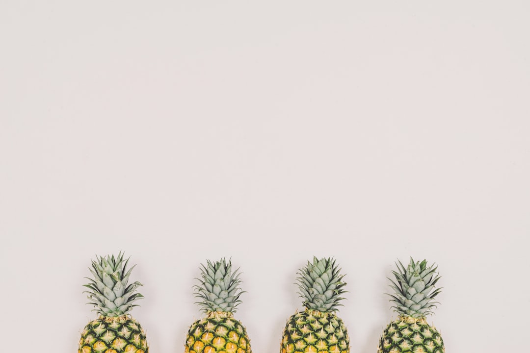 four pineapples on white background