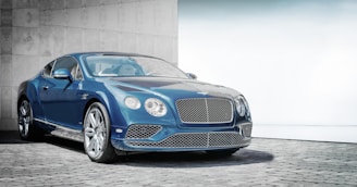 blue coupe on road