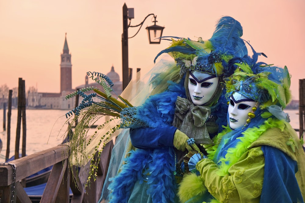 Two people dressed up on a bridge.