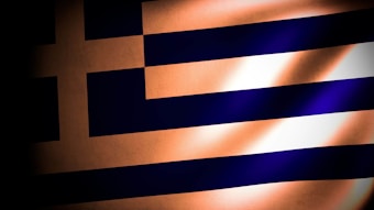 A stylized image of the Greek flag featuring deep shadows and highlights, emphasizing the blue and white stripes and cross. The lighting gives a dramatic and textured appearance to the flag.
