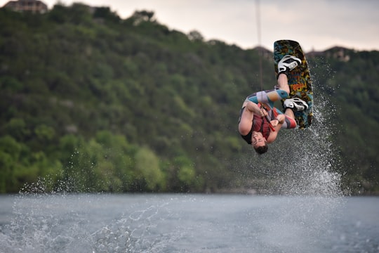 person on wakeboard flipping in Lake Austin United States