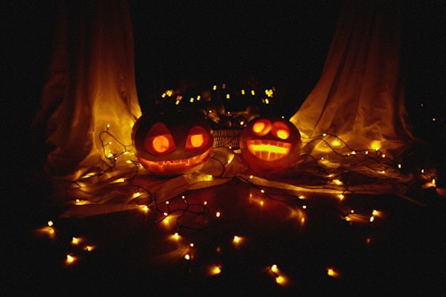 Festive Halloween decorations with pumpkins and spooky lights.
