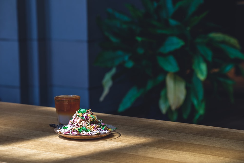 selective focus photography of dish on plate beside mug