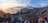A large crowd gathers in an amphitheater to watch a traditional Balinese Kecak dance performance at sunset. Performers are seated in a circular formation, surrounded by ocean views and dramatic cliffs.