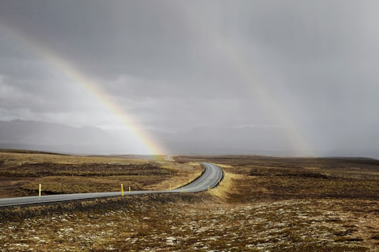 landscape photo of road under the rainbows in Geysir Iceland