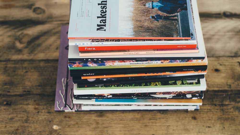 assorted-title softbound book on table