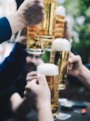 five beer mug filled with beer