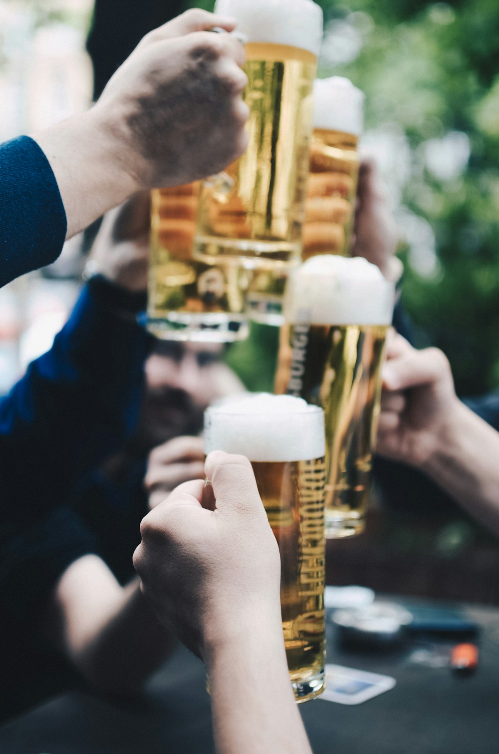 five beer mug filled with beer