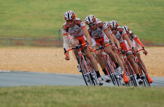 A dynamic team of cyclists racing together on a scenic road.