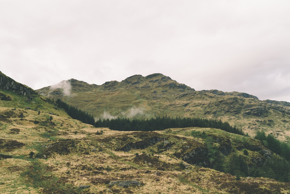 green mountain under cloudy sky