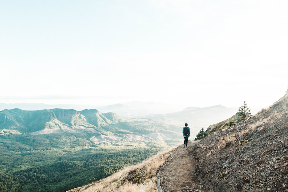 man walking on cliff