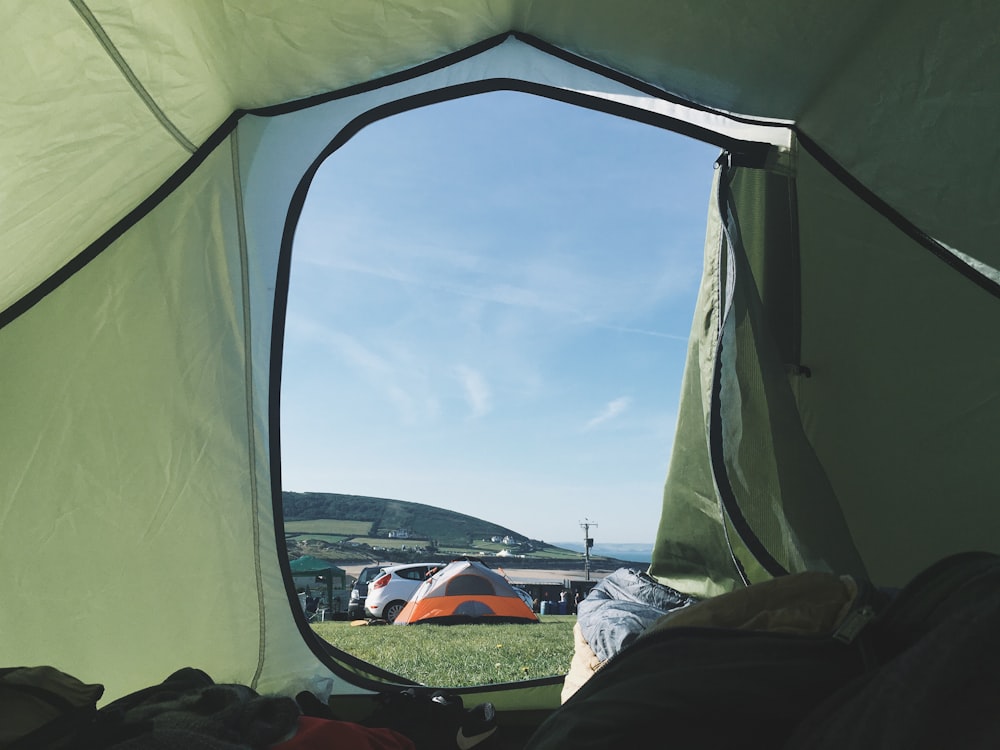 person inside tent with gray and orange tent background outside