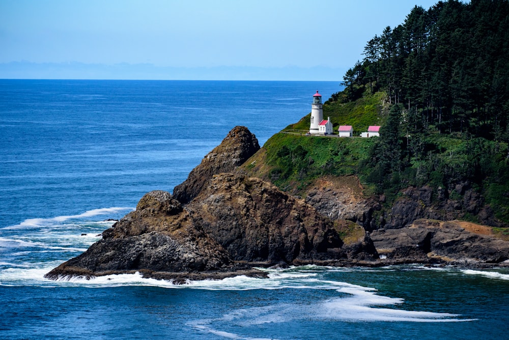 white lighthouse beside sea