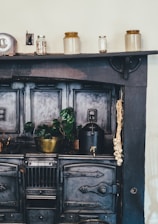 brown wooden kitchen shelf with ceramic jars on top