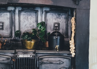 brown wooden kitchen shelf with ceramic jars on top