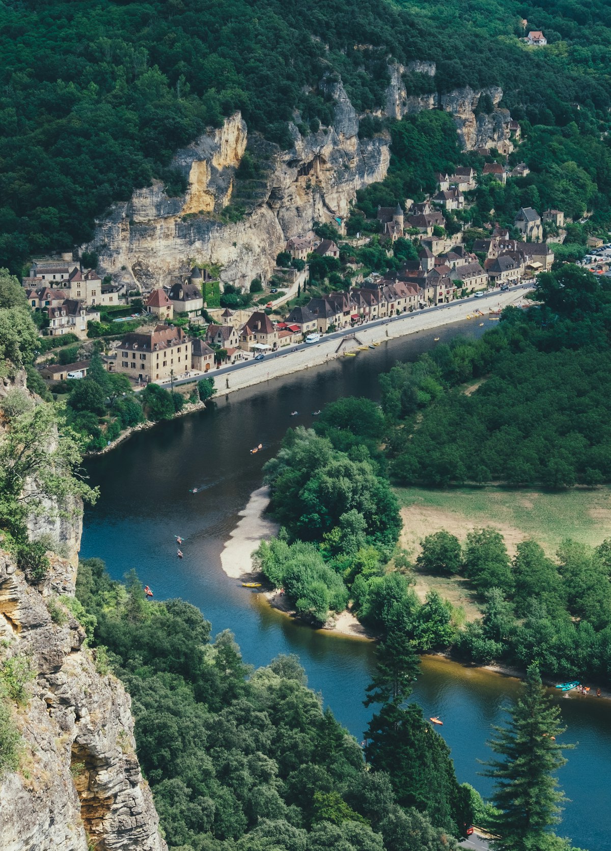 Golden stone village of La Roque-Gageac built into a cliffside above the Dordogne River