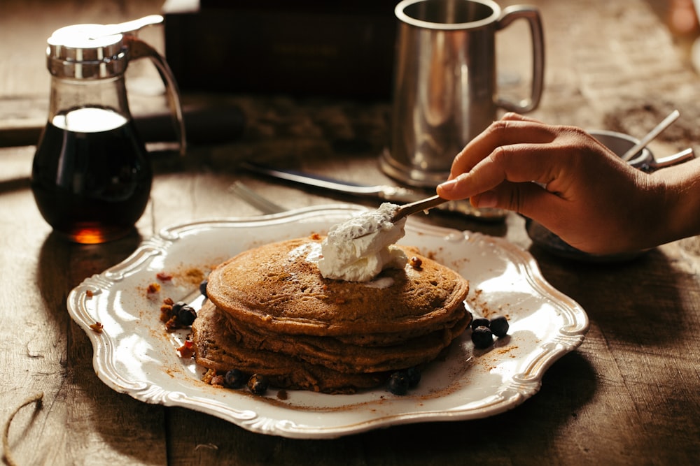 pancake with butter on white ceramic plate