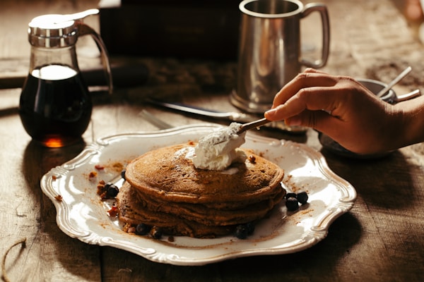 Pancake with butter on white ceramic plate