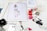 A workspace is filled with feminine fashion illustrations and cosmetic items. Digital drawings are displayed on tablets alongside traditional sketches. Nail polish bottles in various vibrant colors and a Dior makeup box are arranged neatly. The scene blends technology and art in a stylish manner.