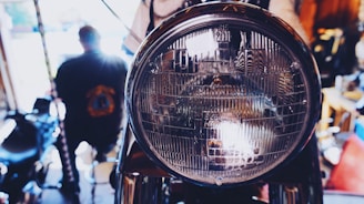 Close-up of a mechanic tuning a motocross bike engine in a workshop.