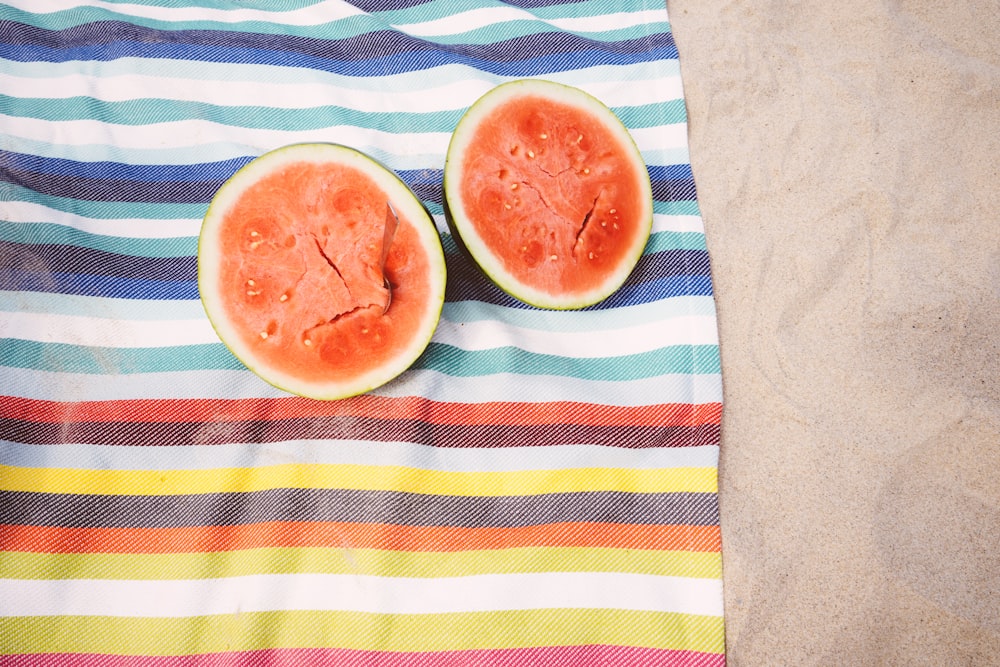 closeup photo of slice watermelon fruits on cloth