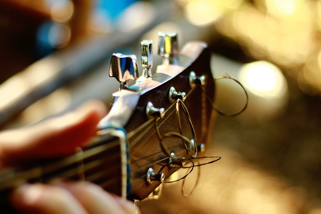 Close-up of the tuning keys of a black guitar