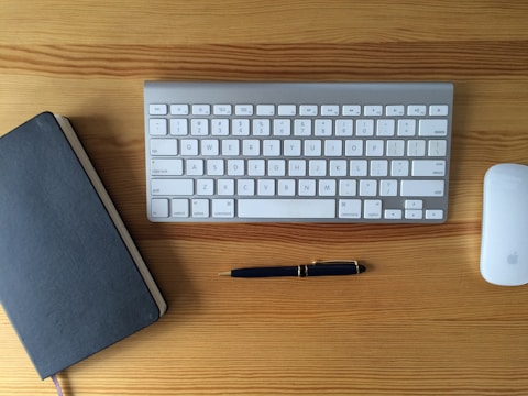 A beautifully finished metal and wood desk organizer resting on a polished wooden surface.