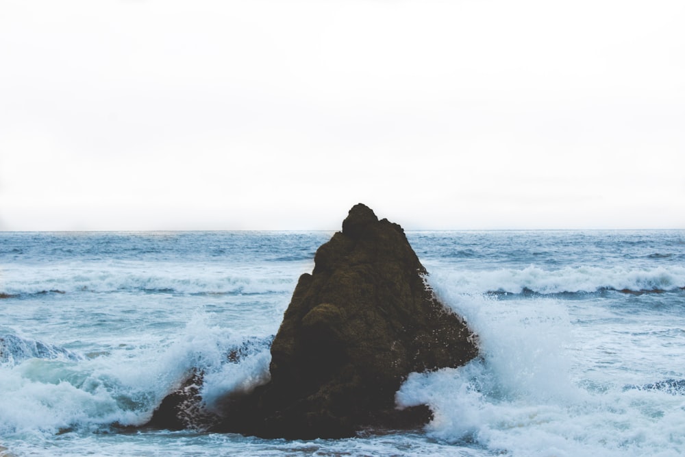 rock formation on body of water