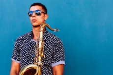 man holding saxophone instrument