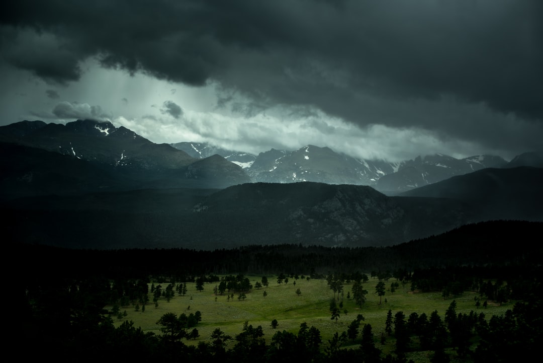 landscape photography of mountains during cloudy skies,