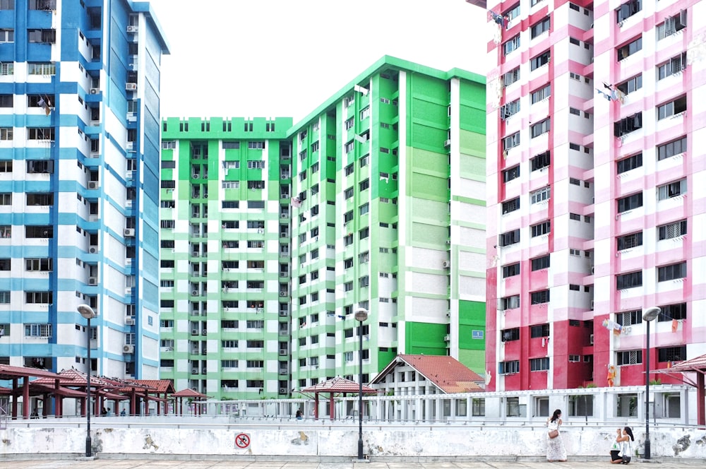 blue, pink, and green high-rise buildings