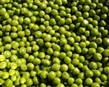 Frozen peas (matar) in transparent packaging with frosty texture.