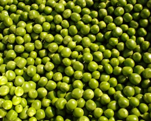 Frozen peas in clear packaging, showcasing their bright green color and freshness.
