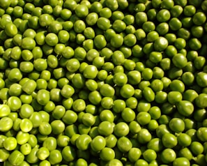 Frozen peas (matar) in transparent packaging with frosty texture.