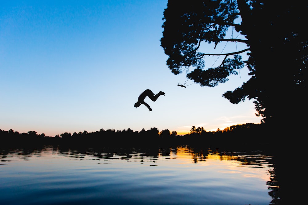 man jump on water at golden hour