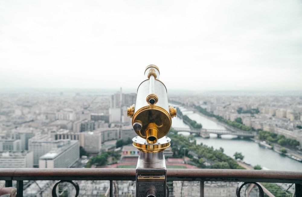 gray and gold-colored telescope on roof